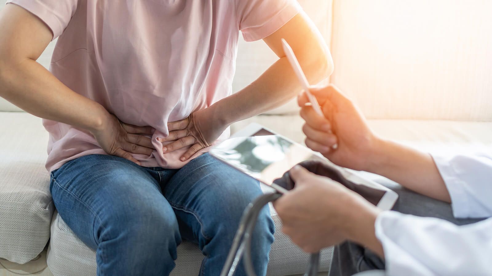 An individual holding their lower abdomen area representing pain. A registered dietitian in Raleigh, NC can help with IBS & other gastrointestinal issues. Call today to begin.