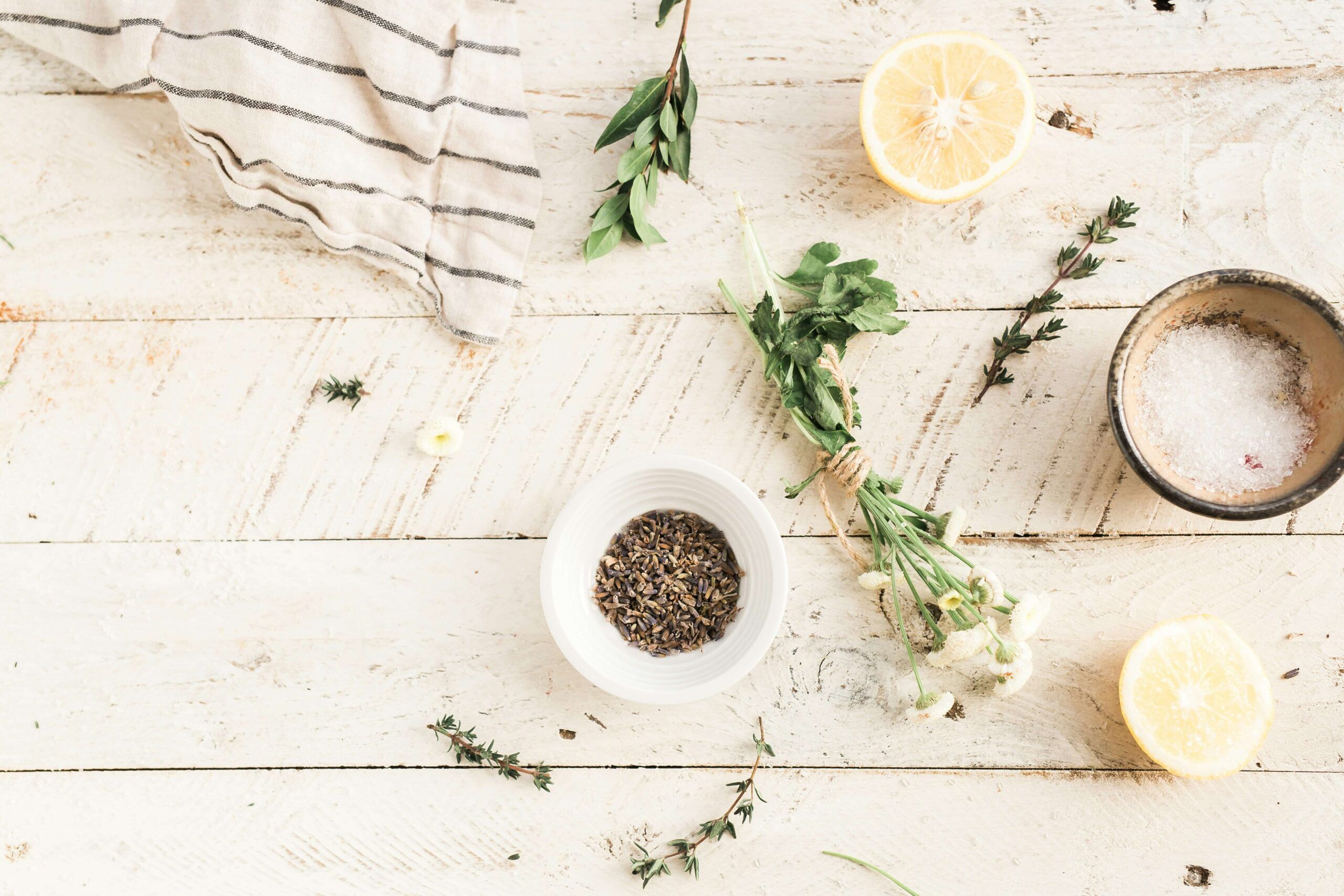 Different spices & lemon slices laid out on a white table. If you would like chronic management support, reach out to us to begin nutrition therapy in Raleigh, NC. Contact us today to begin.