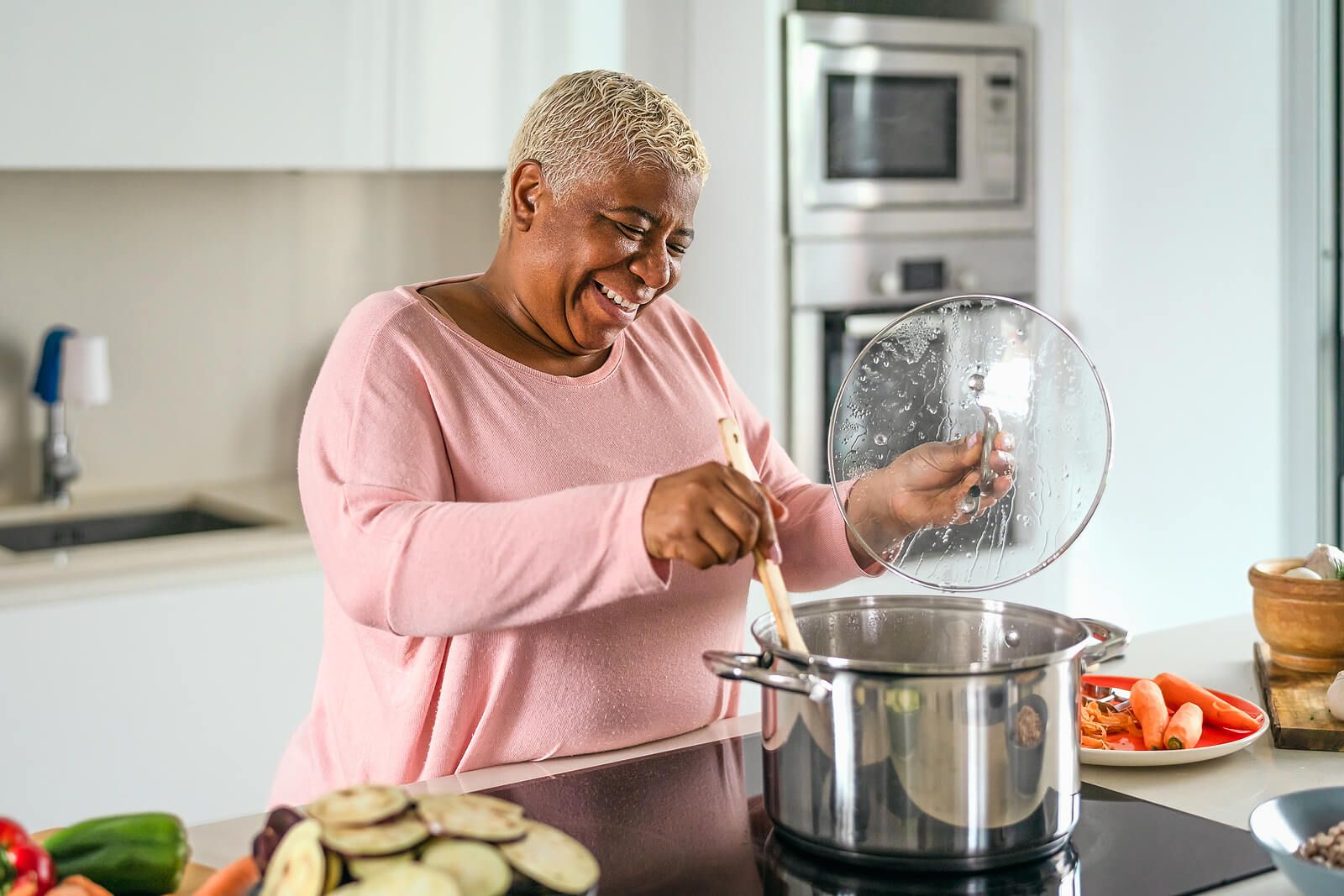 A woman stirring food in a large silver pot on the stove. Discover how our nutrition therapy in Raleigh, NC can help support your recovery journey. Reach out today to get started.