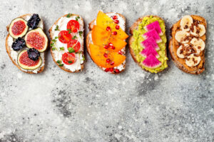 Toasts with delicious looking toppings lined together on a counter. Our nutritional counseling in Raleigh, NC can help you build a better relationship with food. Start eating disorder therapy today. 