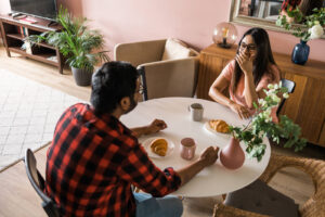 Two individuals eating together at a table. Discover the benefits of nutritional counseling in Asheville, Boone & other areas in North Carolina. Call now to begin!