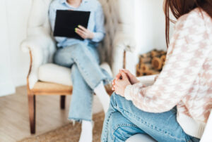 A woman sitting down with a nutritional therapist. Nutritional counseling in Asheville, NC & surrounding areas can help you recover from disordered eating, trauma & more. Get started today! 