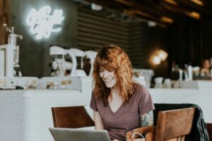 A woman talking to her therapist online at a cafe. With our online eating disorder therapy in Asheville, NC, you can meet with our dietitians at your convenience! Start working with a dietitian today. 