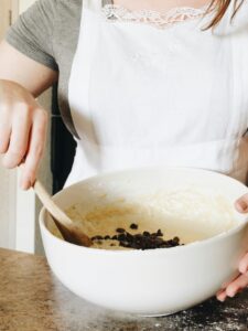 An individual mixing dough in a white mixing bowl. Our medical nutrition therapy can help with gastrointestinal issues, disordered eating & more. Get started with medical nutrition therapy in Raleigh, NC today. 