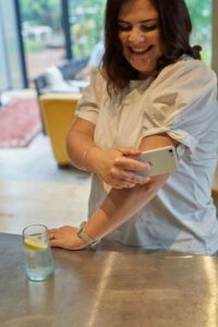 A woman using her phone to check her insulin. Nutrition therapy can help with diabetes management, chronic dieting, & more. Call today to get start with our registered dietitians in Raleigh, NC. 