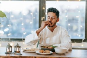 A man enjoys a mindful meal, embracing a balanced approach to food with nutrition therapy in Raleigh, NC. A dietitian in Hendersonville, NC can provide guidance to support intuitive eating and overall well-being.